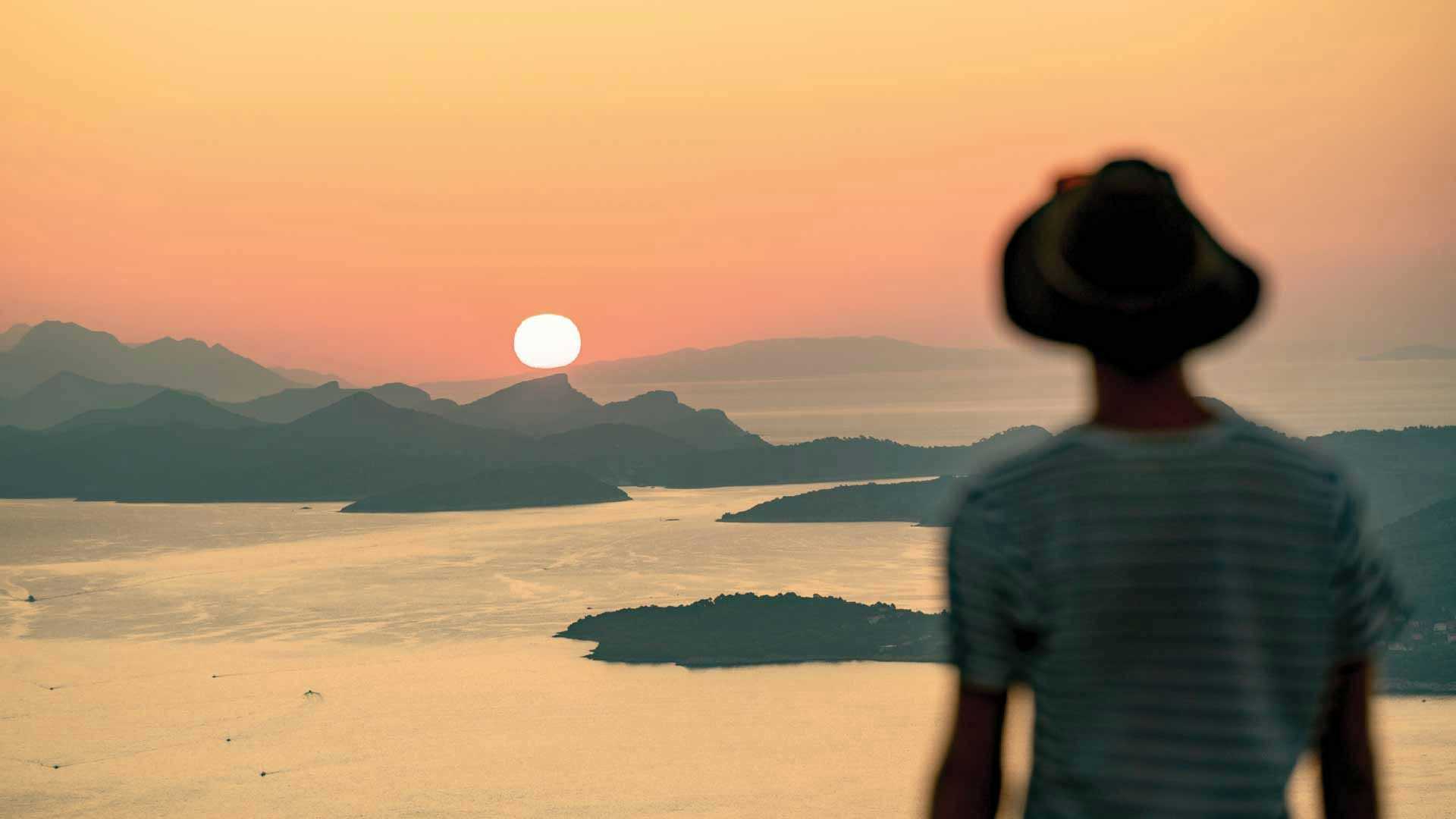 Man looking at the sunset over Croatian islands