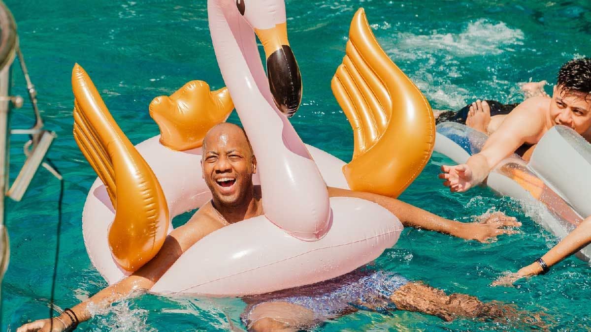 Man having fun on an inflatable flamingo