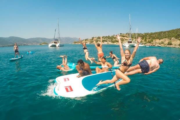 Image of friends playing around on a MedSailors paddleboard