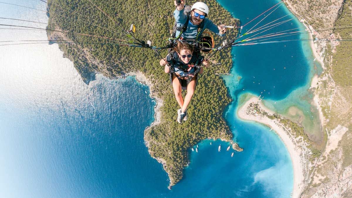 Woman paragliding over Oludeniz Beach in Turkey