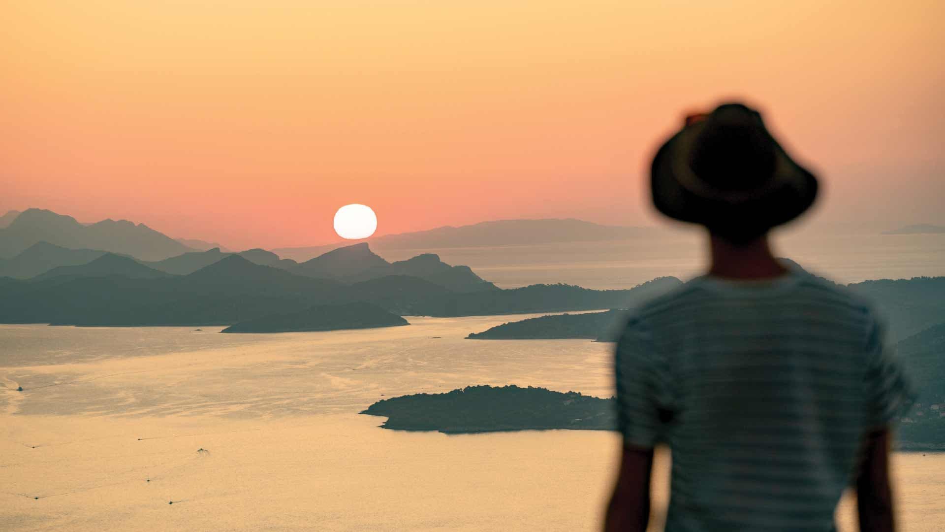 Man looking at the view over Dubrovnik at sunset