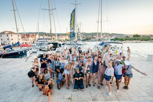 Image of group of people in front of a yacht