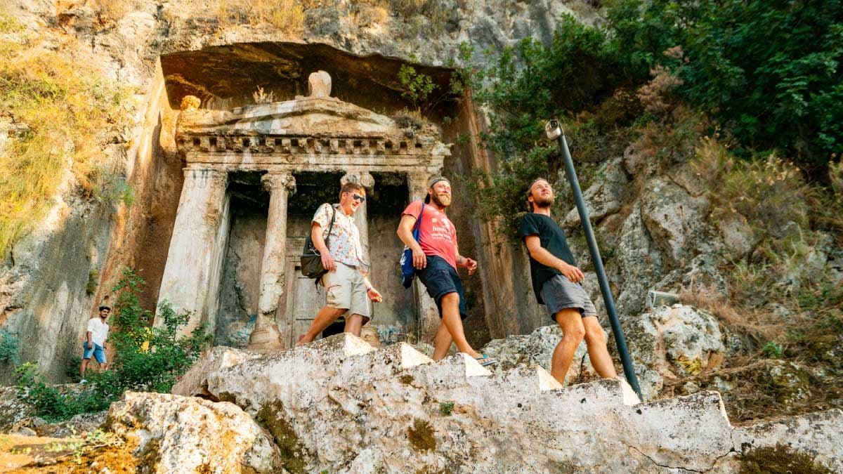 Group of people walk through Kayakoy ruins