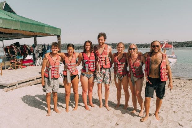 Group of friends prepare for water sports in Greece
