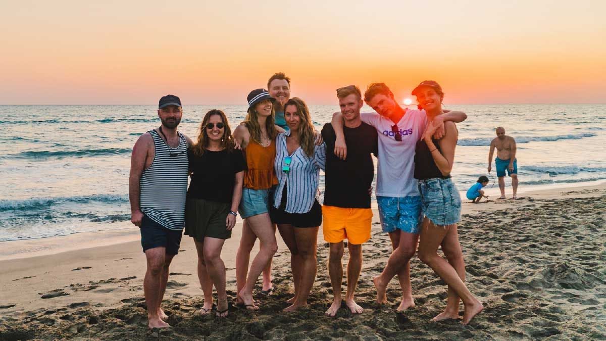 Friends pose for a photo at sunset on Patara Beach