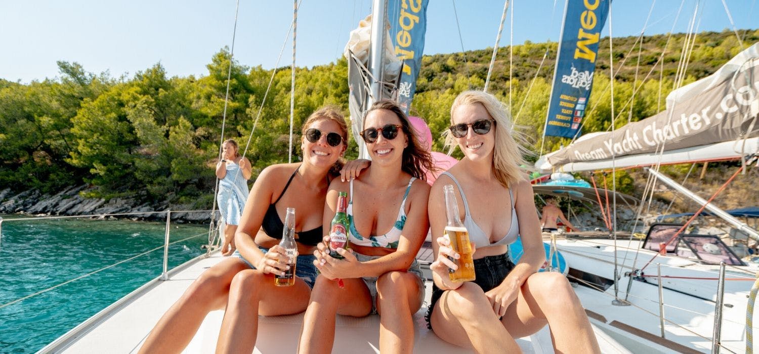 MedSailors guests sharing a beer together on a yacht