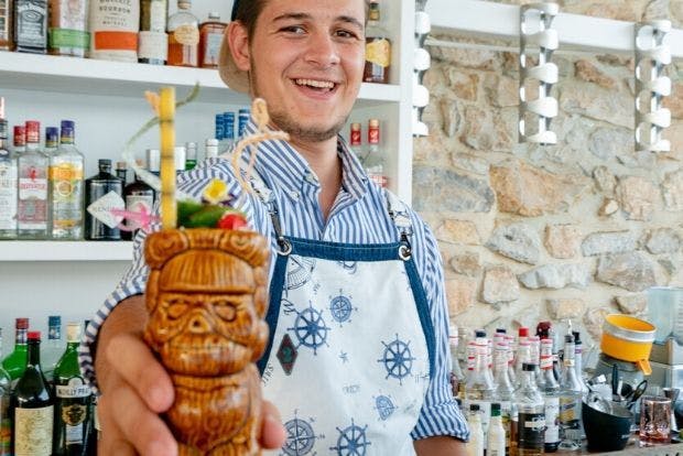 Thanos serving a cocktail in Greece