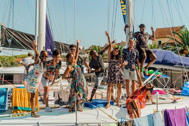 Group of friends dancing on a yacht