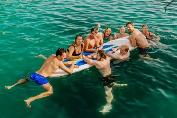 MedSailors guests floating on a paddleboard