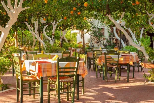 Photo of orange groves and restaurant in Epidavros Greece.