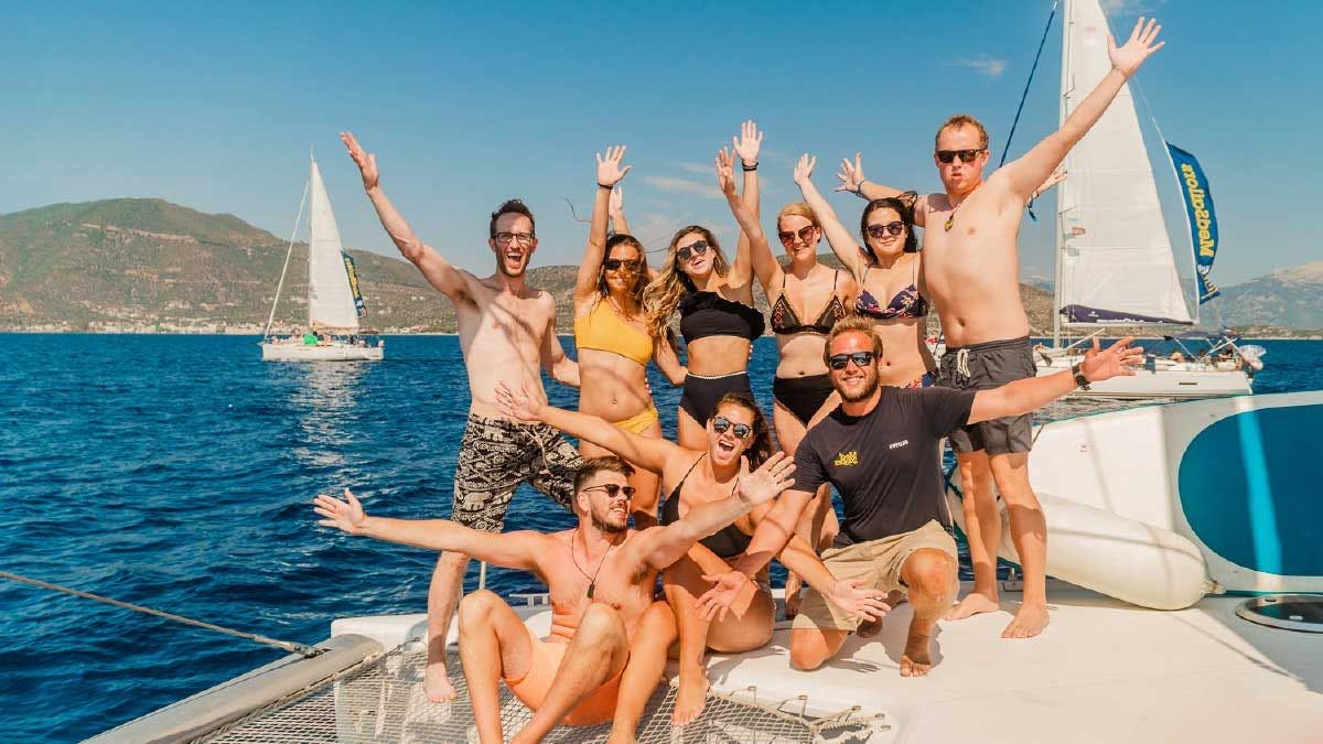 Group of friends pose for a photo on a MedSailors catamaran