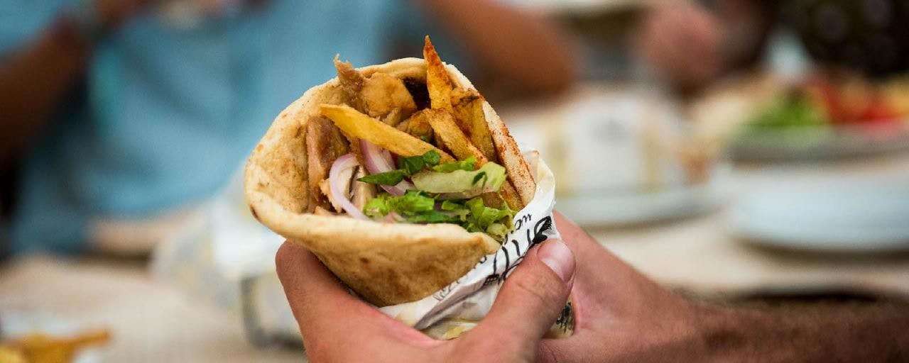 Person holding a gyros